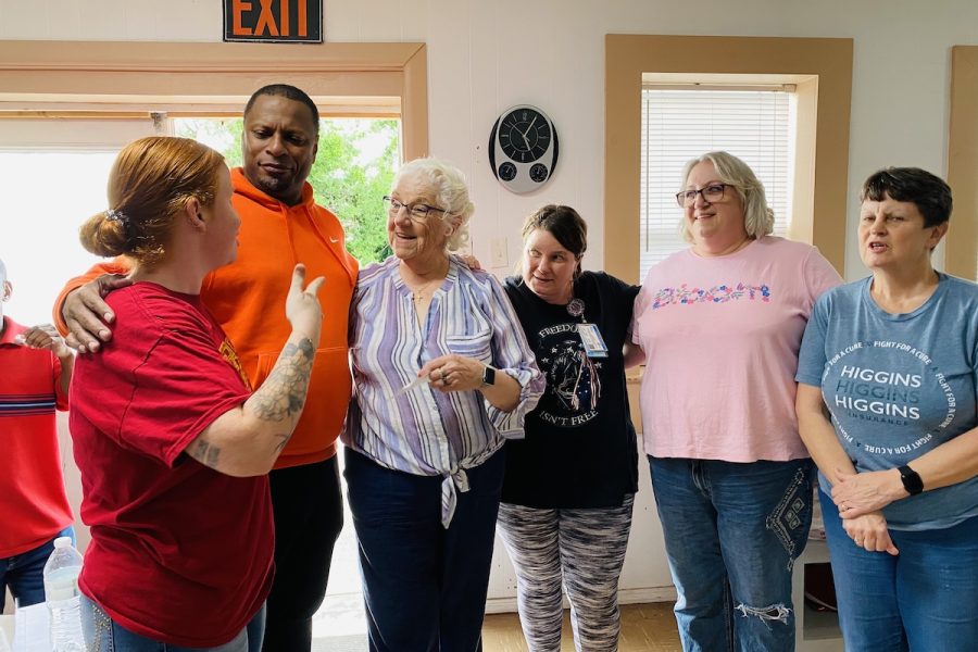 Retired NBA player Chris Whitney huddles up with dinner church volunteers (from left) Abby Hess. Donna Williams, Crystal Carn, Paige Bates and Amy Montgomery on Thursday, May 2, 2024, at Aaron McNeil House. (Hoptown Chronicle photo by Jennifer P. Brown)