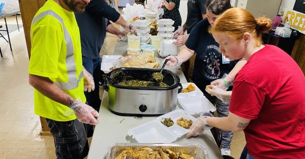 Volunteers plate smoked chicken, green beans, potato salad and rolls on Thursday, May 2, 2024, for the Breaking Bread Community Dinner Church. (Hoptown Chronicle photo by Jennifer P. Brown)