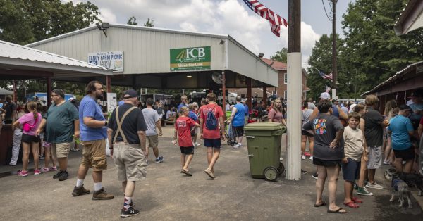 People walk by pavilions on Saturday, Aug. 3, 2024, during St. Jerome Picnic in Fancy Farm, Ky. (Austin Anthony for the Kentucky Lantern)