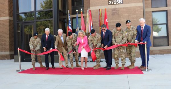 Lawmakers from Tennessee and Kentucky join military officers to cut the ribbon a newly renovated barracks at Fort Campbell military base. (Photo by Lily Burris | WKMS)