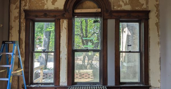 The parlor of the Dalton house with its damaged radiator shortly after Grace and Brendan Abernethy bought the house. (Photo by Grace Abernethy)