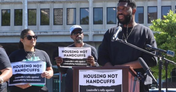 louisville homelessness rally participants holding signs