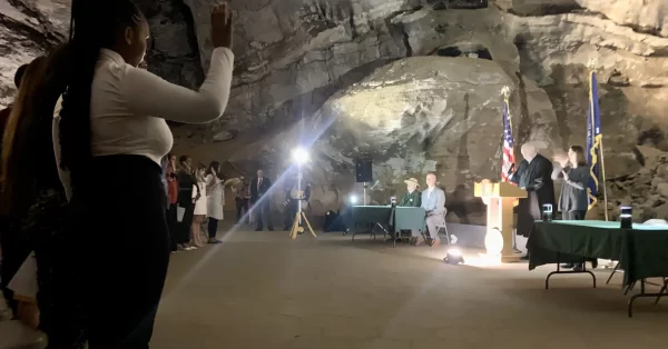 people raising hands in mammoth cave