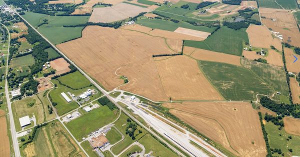 An aerial view shows a 378-acre tract (above the CSX rail line) that a Wisconsin meatpacking company has considered for a massive slaughterhouse. The land is on John Rivers Road. The town of Pembroke is visible in the upper left corner of the photo. (Image from South Western Kentucky Economic Development Council)