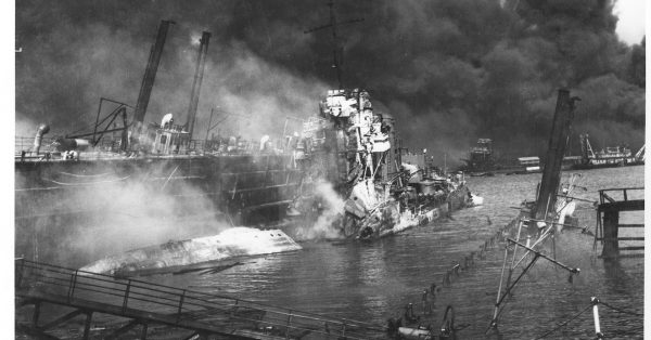 The USS Shaw lies in drydock after being hit by three bombs which exploded her forward magazine in the Dec. 7, 1941, Japanese attack on Pearl Harbor. Part of the drydock at right is under water while while the other side is listing heavily. (Photo from U.S. National Archives)