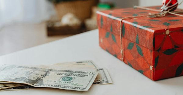 money next to christmas gift