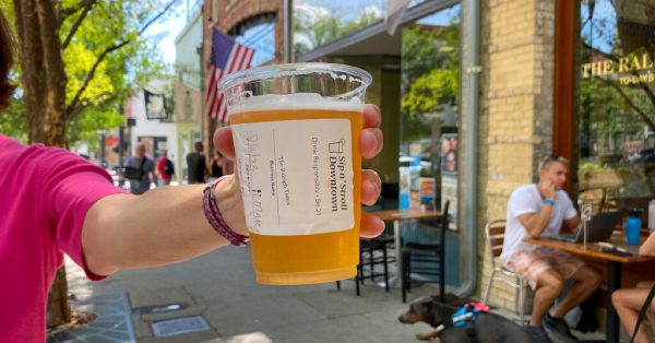 A specially marked cup shows a beer purchased in Raleigh’s Sip n’ Stroll Downtown, a special social district the North Carolina capital created last year that allows open containers of alcohol within strict bounds. States, including Kentucky, are increasingly allowing cities to create these districts in hopes of boosting — or reviving — downtown businesses. (Photo courtesy of the city of Raleigh, N.C.)
