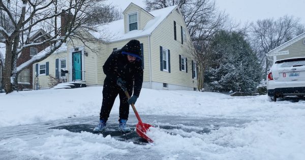 Jacob Farnsley, of Kingsport, Tennessee, shovels snow Thursday from a driveway on Mooreland Drive. He was in town visiting family when the snow hit. (Photo by Jennifer P. Brown)