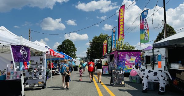 Summer Salute festival-goers walk along West Ninth Street, lined with food trucks and vendor and community booths, on Friday, Aug. 23, 2024. (Hoptown Chronicle photos by Jennifer P. Brown)