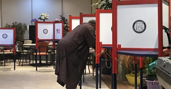 A resident of the Elliott Park apartments was the first one to vote, in his robes and slippers, on Election Day in 2022.