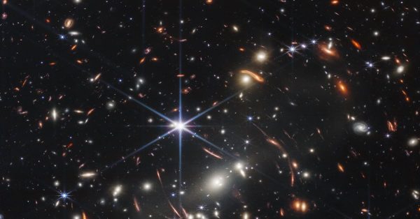 This photo shows gravitational lensing and many bright galaxies, but the smaller, fainter, less distinct galaxies in this image are some of the oldest light ever detected by a human-made object. (NASA image)
