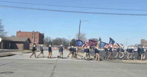 white supremacists walking with flags