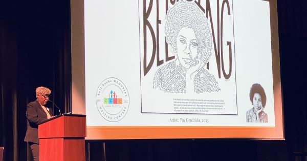 Gwenda Motley reads from her sister bell hooks' book, "Belonging: A Culture of Place," during a ceremony Sunday, March 19, 2023, at the Performing Arts Center at Christian County Middle School, where winners in a writing contest were recognized. (Hoptown Chronicle photo by Jennifer P. Brown)